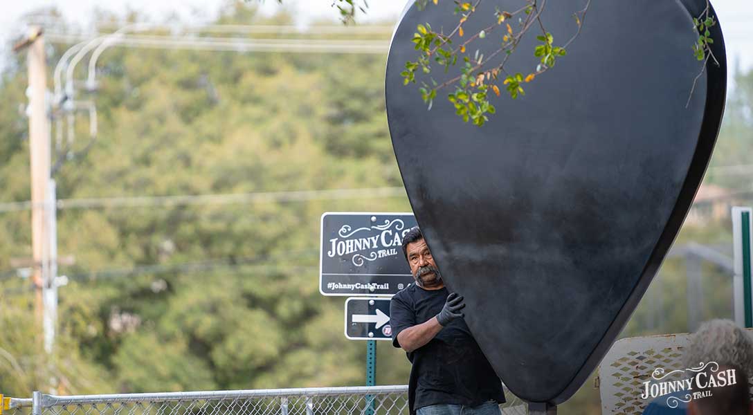 Image of a Folsom City worker assisting with the installation of Cash's Pic No. 1 art piece.