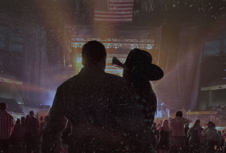 Image of two country music fans ejoying a live peformance.